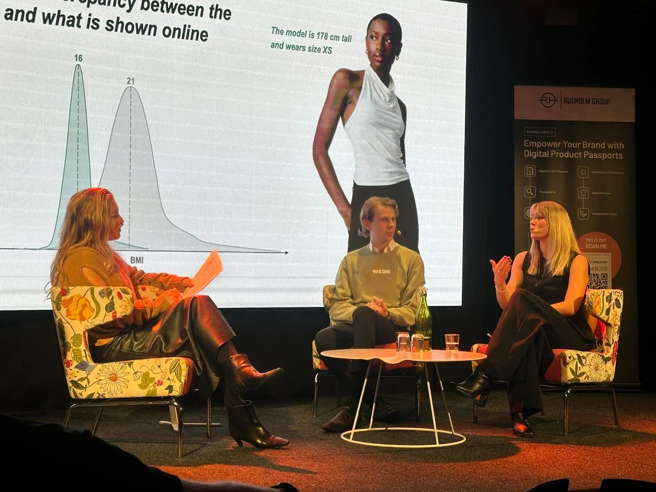 Weon discussing online fashion sizing on stage with industry leaders